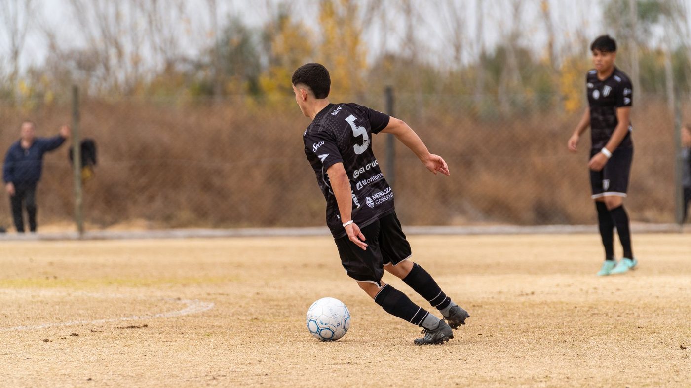 Two older youth players contesting the ball in a match, the level the xGI management arm prepares players for